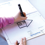 Child sketching an idea for a cardboard house in the Chompshop Inventor's Workbook, a guide to teach engineering and design thinking.