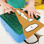 Chompsaw being used to cut a printed pattern of an airplane that has been glued onto a piece of cardboard