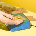 Young maker cutting a cardboard piece with the ChompSaw kids power tool.