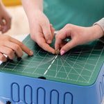 Kids touching the ChompSaw's cutting head to demonstrate being finger-safe