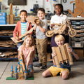 Kids holding a variety of cardboard projects made with the ChompSaw.